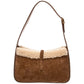 Brown suede handbag with beige shearling lining on a white background
