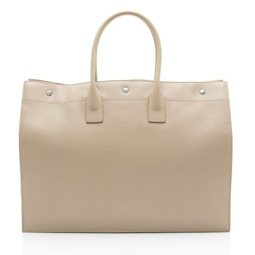 Beige handbag with silver hardware on a white background