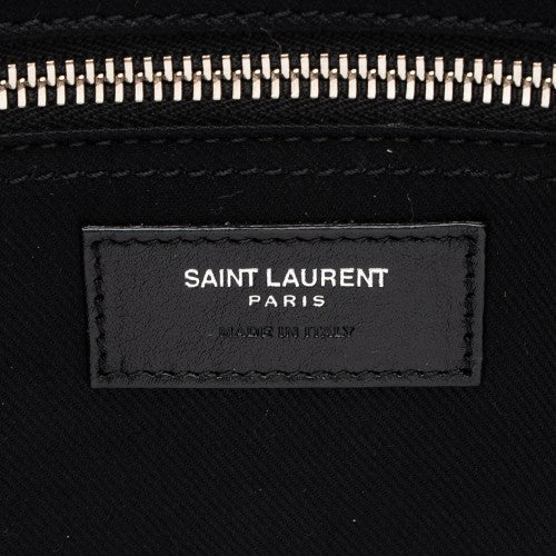 Saint Laurent Paris logo on a black textured background