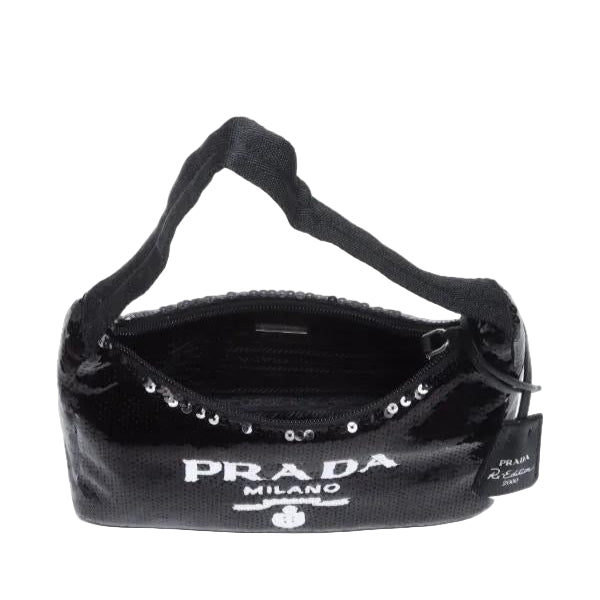 Black Prada handbag with studded details on a white background