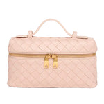 Quilted pink makeup bag with a gold zipper on a white background