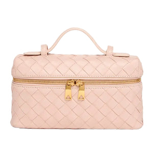 Quilted pink makeup bag with a gold zipper on a white background
