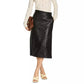 Woman wearing a white polka dot shirt and black leather skirt on a white background