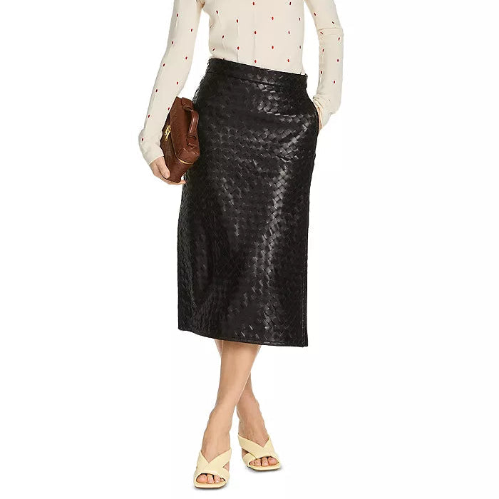 Woman wearing a white polka dot shirt and black leather skirt on a white background
