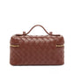 Brown woven handbag with gold zipper on a white background