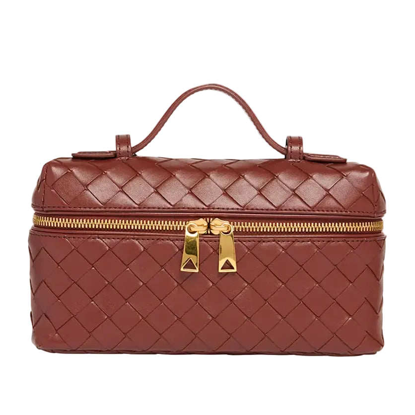 Brown woven handbag with gold zipper and handle on a white background