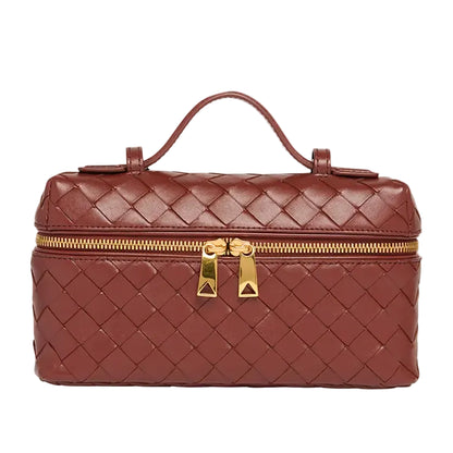 Brown woven handbag with gold zipper and handle on a white background