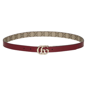 Red belt with beige monogrammed strap on a light gray background