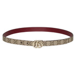 Designer belt with brand logo on a light gray background