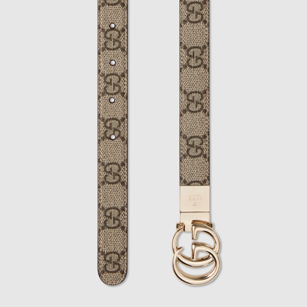 Beige belt with a gold buckle on a light gray background