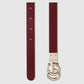 Burgundy belt with a gold double G buckle on a light gray background