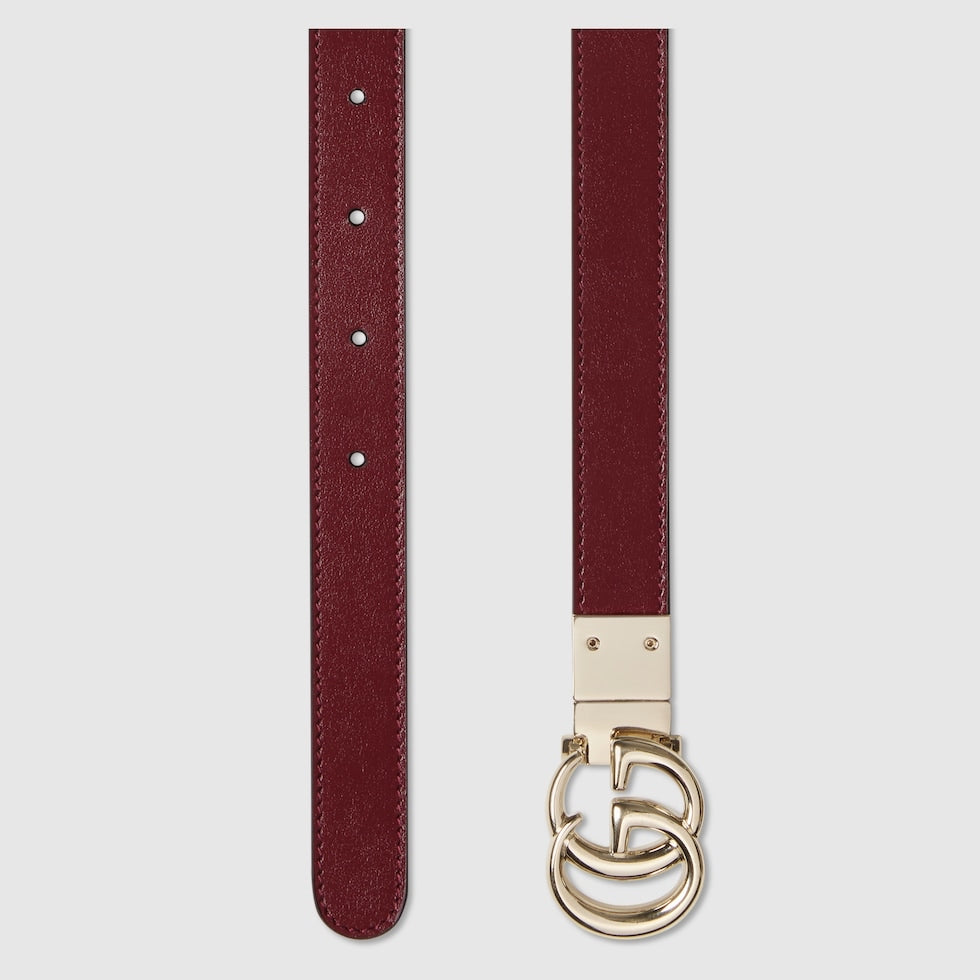 Burgundy belt with a gold double G buckle on a light gray background