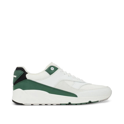 White sneaker with green and black pattern on a white background