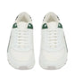 White sneakers with green accents on a white background