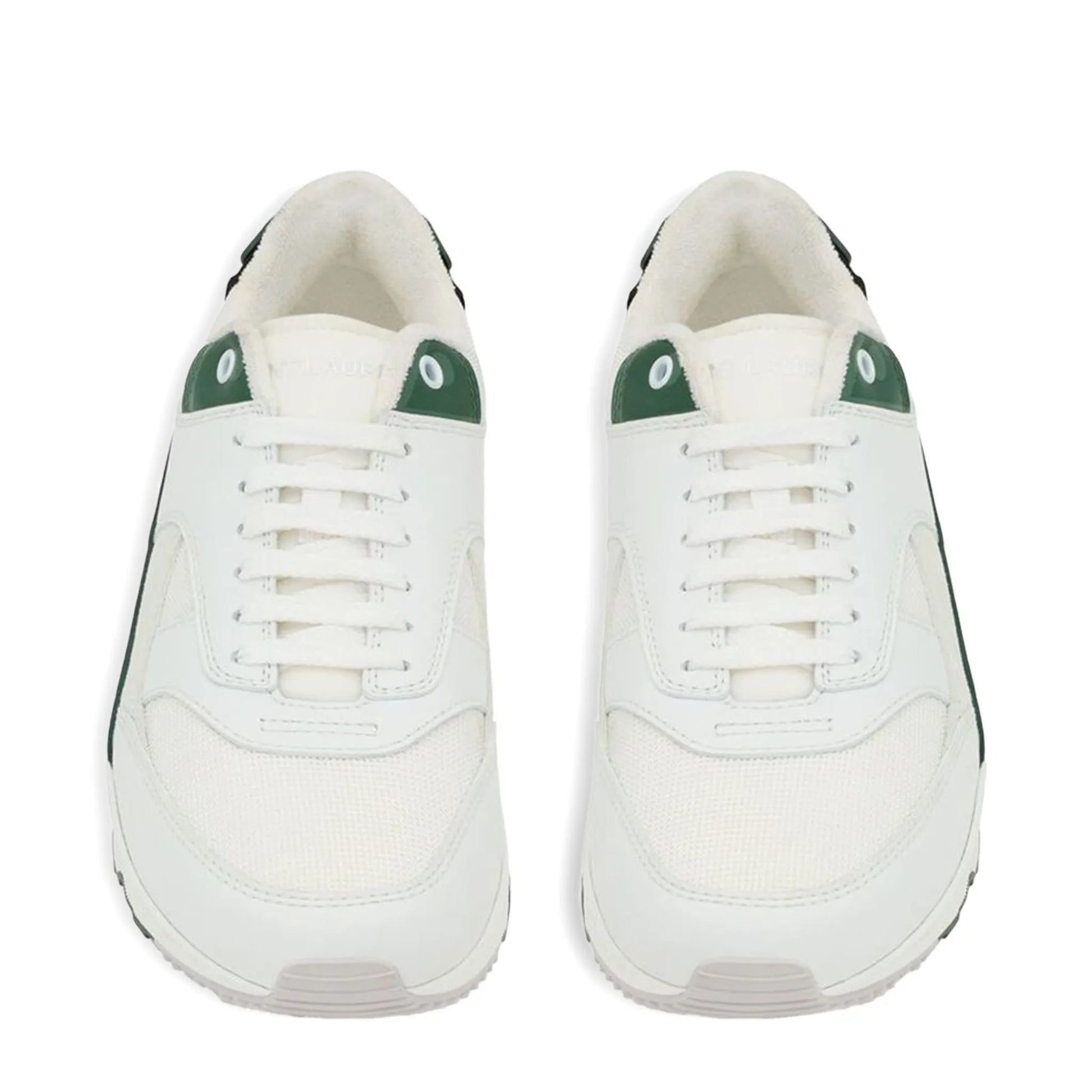White sneakers with green accents on a white background