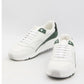 White sneakers with green accents on a light gray background