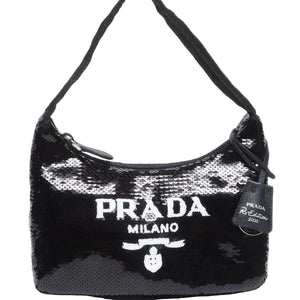Black sequin handbag with Prada logo on a white background