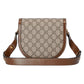 Gucci handbag with monogram pattern on a white background