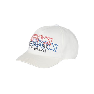 White baseball cap with Gucci embroidery on a gray background