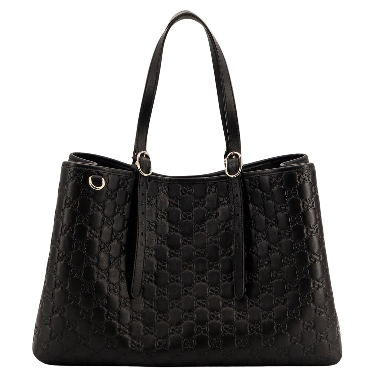 Black quilted handbag on a light gray background