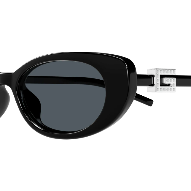 Black sunglasses with a decorative metal detail on a white background