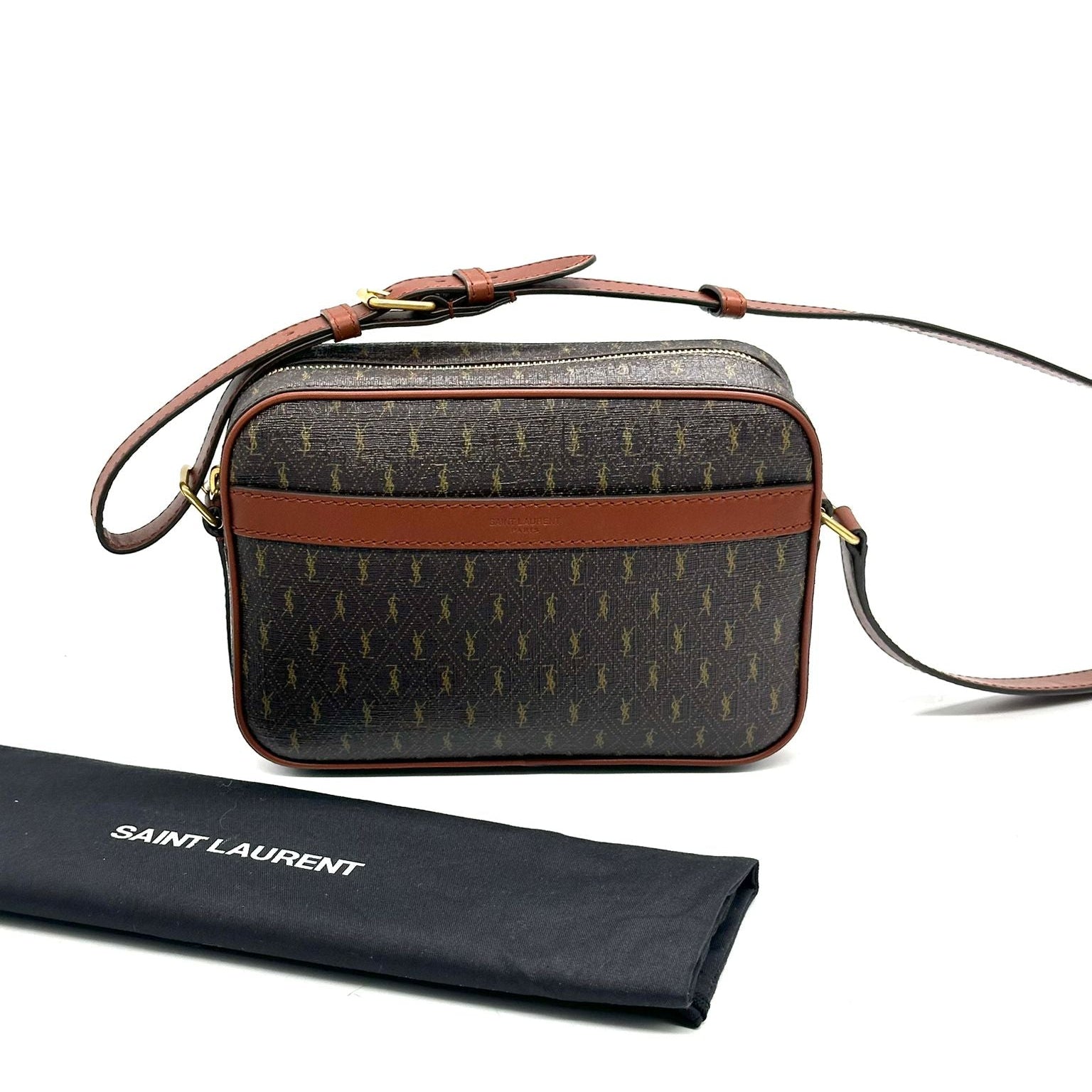 Designer handbag with brown strap and patterned body, next to a Saint Laurent branded pouch on a white background.
