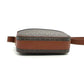 Small crossbody bag with brown leather strap and textured fabric body on a white background