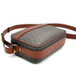 Gray crossbody bag with brown leather accents on a white background