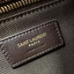 Saint Laurent Paris label on a textured surface