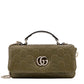 Green handbag with Gucci logo on a white background