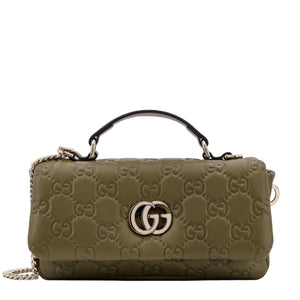 Green handbag with Gucci logo on a white background