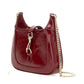Red handbag with a gold chain on a white background