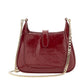 Red handbag with a gold chain on a white background