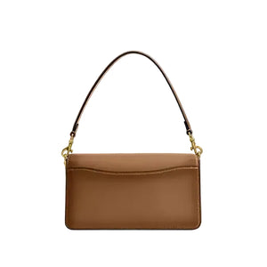 Brown handbag with a strap on a light gray background